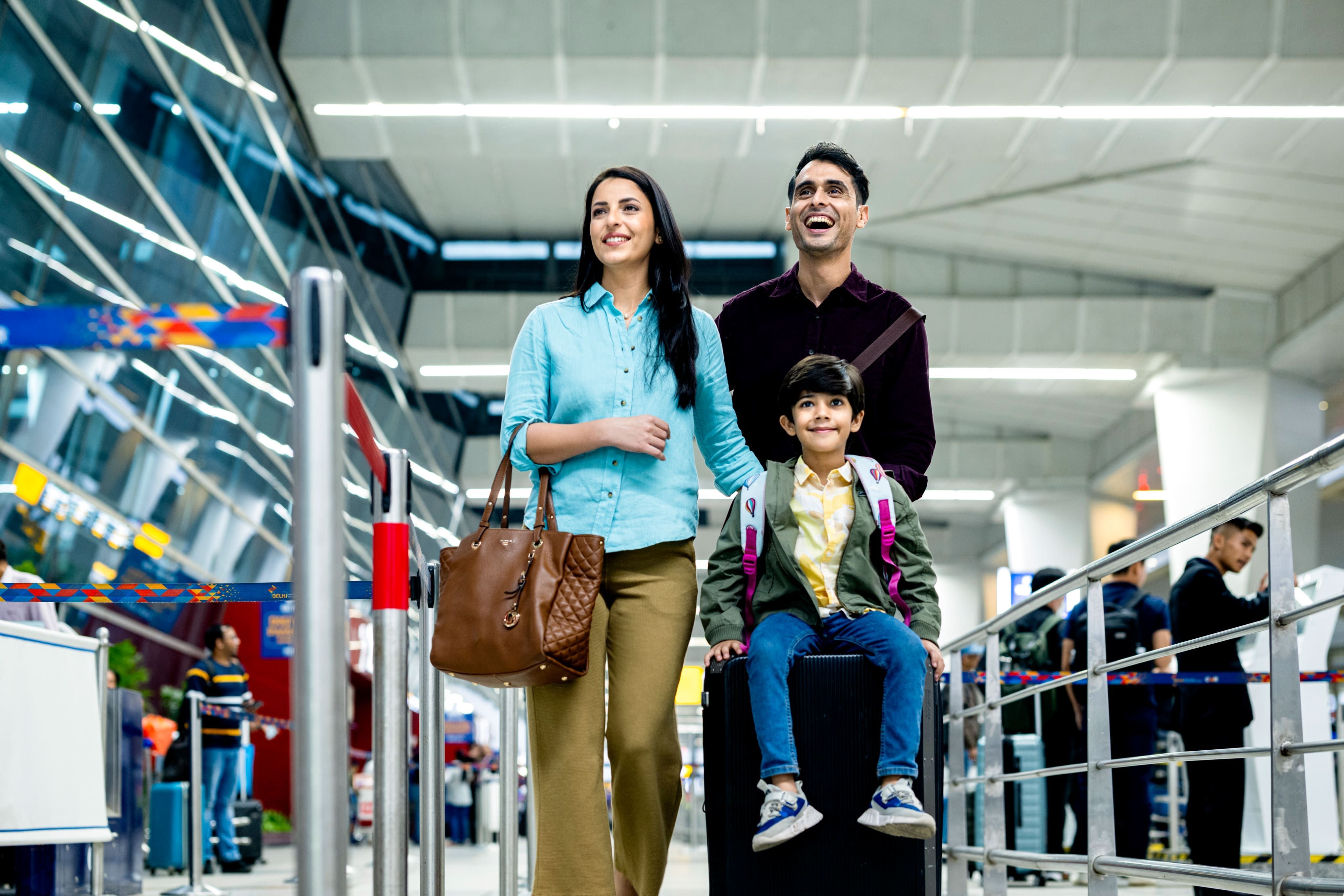 Family walking through the airport with luggage