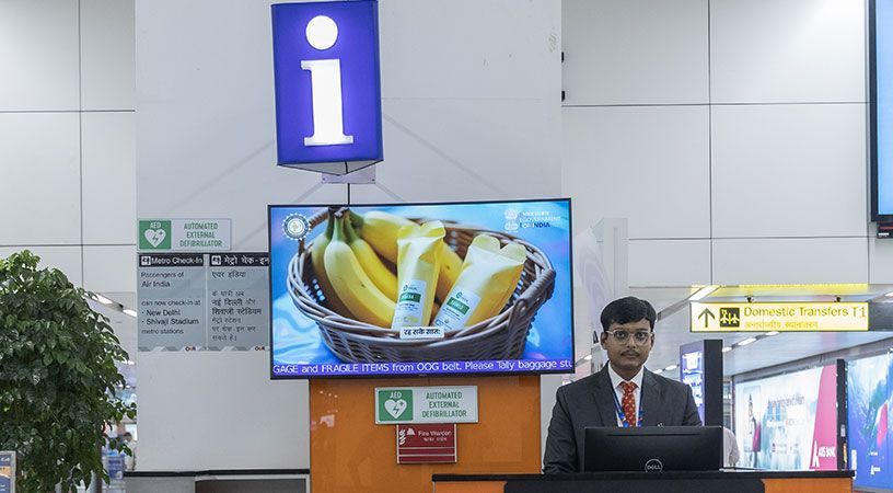 Airport information desk with staff assistance.