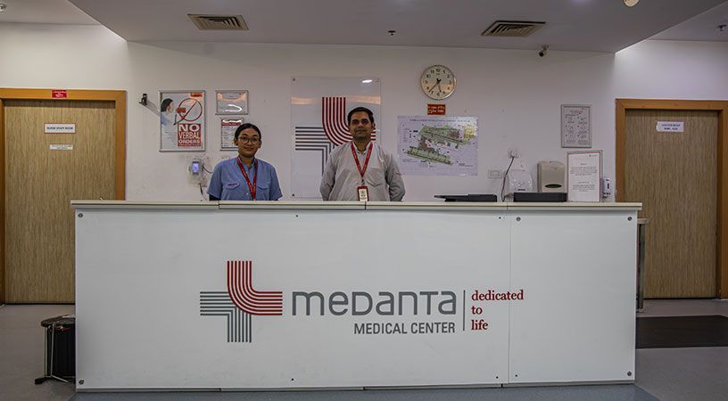 Staff standing behind the reception desk at a medical center.