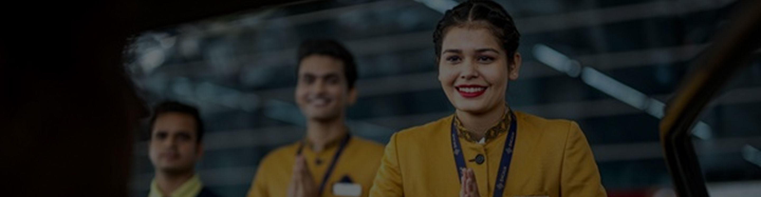Airport staff greeting passenger with folded hands